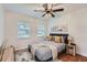 Cozy bedroom with a queen-sized bed, stylish decor, and natural light from two windows at 1145 53Rd N Ave, St Petersburg, FL 33703