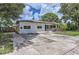 Freshly painted white brick house with lush landscaping, a tidy yard and updated exterior elements at 1145 53Rd N Ave, St Petersburg, FL 33703