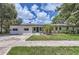 Inviting single-story home boasts a freshly painted white brick exterior and tidy front yard landscaping at 1145 53Rd N Ave, St Petersburg, FL 33703