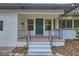 Inviting front porch featuring a freshly painted door, updated railings, and white brick accents at 1145 53Rd N Ave, St Petersburg, FL 33703