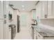 Spacious kitchen features granite counters, stainless appliances, and white cabinets with black hardware at 1145 53Rd N Ave, St Petersburg, FL 33703