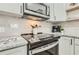 Updated kitchen with stainless steel appliances, and stylish countertops at 1145 53Rd N Ave, St Petersburg, FL 33703