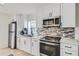 Modern kitchen with stainless steel appliances, stylish backsplash, and sleek countertops at 1145 53Rd N Ave, St Petersburg, FL 33703