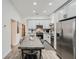 Spacious eat-in kitchen with modern gray cabinets, stainless appliances, and a large dining table at 1145 53Rd N Ave, St Petersburg, FL 33703