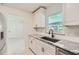 Bright, white kitchen featuring granite countertops, white cabinets, and stainless steel appliances at 1145 53Rd N Ave, St Petersburg, FL 33703