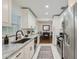 Bright kitchen features white cabinets, granite counters, stainless steel appliances, and an open dining area at 1145 53Rd N Ave, St Petersburg, FL 33703