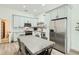 Bright eat-in kitchen featuring gray cabinets, stainless steel appliances, and a dining table with seating for six at 1145 53Rd N Ave, St Petersburg, FL 33703