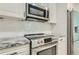 Updated kitchen features stainless steel appliances, granite countertops, and white tile backsplash at 1145 53Rd N Ave, St Petersburg, FL 33703