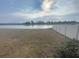 Backyard featuring a lake and white fence at 11524 Sage Canyon Dr, Riverview, FL 33578