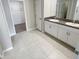 Bright bathroom with double vanity, granite counters, and walk-in closet at 11524 Sage Canyon Dr, Riverview, FL 33578