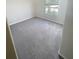 Bright bedroom features soft gray carpet, neutral walls, and a window that provides plenty of natural light at 11524 Sage Canyon Dr, Riverview, FL 33578