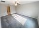 Cozy bedroom with plush carpeting, a ceiling fan, and ample natural light streaming through the windows at 11524 Sage Canyon Dr, Riverview, FL 33578