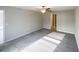 Well-lit bedroom with soft carpeting, a ceiling fan, and an open doorway to another room at 11524 Sage Canyon Dr, Riverview, FL 33578