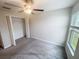 Well-lit bedroom with carpet flooring and closet space at 11524 Sage Canyon Dr, Riverview, FL 33578