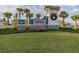 Welcoming community sign for Ventana, adorned with a wreath, surrounded by lush landscaping and palm trees at 11524 Sage Canyon Dr, Riverview, FL 33578