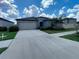 Charming single-story home featuring a neutral color palette, a two-car garage, and well-maintained landscaping at 11524 Sage Canyon Dr, Riverview, FL 33578