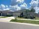 Charming single-story home featuring a neutral color palette, a two-car garage, and well-maintained landscaping at 11524 Sage Canyon Dr, Riverview, FL 33578