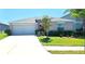 Charming single-story home featuring a well-manicured lawn and a spacious two-car garage at 11524 Sage Canyon Dr, Riverview, FL 33578