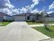 Charming single-story home featuring a neutral color palette, a two-car garage, and well-maintained landscaping at 11524 Sage Canyon Dr, Riverview, FL 33578
