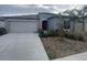 Charming single-story home featuring a two-car garage, red front door and neatly landscaped yard at 11524 Sage Canyon Dr, Riverview, FL 33578