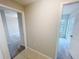 Bright hallway featuring tile flooring and doorways leading to carpeted rooms at 11524 Sage Canyon Dr, Riverview, FL 33578