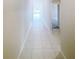 Long tiled hallway providing views to various rooms at 11524 Sage Canyon Dr, Riverview, FL 33578