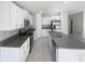 Modern kitchen featuring white cabinets, granite countertops, a center island, and stainless steel appliances at 11524 Sage Canyon Dr, Riverview, FL 33578