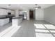 Bright, open concept living space showcasing a modern kitchen, stainless steel appliances, and tile floors at 11524 Sage Canyon Dr, Riverview, FL 33578
