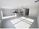 Bright and airy living room featuring tile floors, a kitchen island, and stainless steel appliances at 11524 Sage Canyon Dr, Riverview, FL 33578