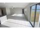 Bright living room featuring tile floors and large sliding glass doors leading to outdoor view at 11524 Sage Canyon Dr, Riverview, FL 33578