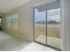 Bright and airy living room showcasing tile floors and a sliding door with a scenic lake view at 11524 Sage Canyon Dr, Riverview, FL 33578