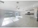 Inviting open living space with tile flooring, neutral walls, and a bright kitchen with stainless appliances at 11524 Sage Canyon Dr, Riverview, FL 33578