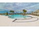Community pool featuring palm trees, lounge chairs, and a shallow beach entry at 11524 Sage Canyon Dr, Riverview, FL 33578