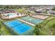 Aerial view showcasing the community's resort-style amenities, including sports courts and pool at 12687 Retreat Pl, Spring Hill, FL 34610