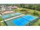 Aerial view of community amenities with playground, basketball and tennis courts, and a pond at 12687 Retreat Pl, Spring Hill, FL 34610
