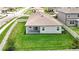 Aerial view of the back of the property featuring large grassy backyard and covered patio at 12687 Retreat Pl, Spring Hill, FL 34610