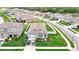 Aerial view of a home with a well-manicured lawn, landscaping and white vinyl fence at 12687 Retreat Pl, Spring Hill, FL 34610