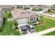 Aerial view of a house with an attached two car garage and well-manicured lawn at 12687 Retreat Pl, Spring Hill, FL 34610