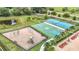 Aerial view of various community amenities, including tennis and basketball courts, and a playground at 12687 Retreat Pl, Spring Hill, FL 34610