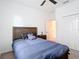 Well-lit bedroom with closet, ceiling fan, and nightstand, creating a cozy and functional space at 12687 Retreat Pl, Spring Hill, FL 34610