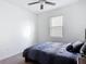 Cozy bedroom with a ceiling fan, a window, and comfortable bedding, creating a relaxing space at 12687 Retreat Pl, Spring Hill, FL 34610