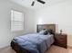 Comfortable bedroom featuring a window, ceiling fan, and nightstand, creating a restful retreat at 12687 Retreat Pl, Spring Hill, FL 34610