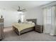 Bedroom featuring a large bed, nightstands, neutral color, and plenty of natural light, great for relaxation at 12687 Retreat Pl, Spring Hill, FL 34610