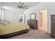 Bright Primary bedroom with a bed, dresser, and neutral decor, creating a peaceful retreat at 12687 Retreat Pl, Spring Hill, FL 34610