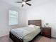 Bright bedroom with a ceiling fan, a window, and a nightstand providing a tranquil space at 12687 Retreat Pl, Spring Hill, FL 34610
