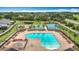 Aerial view of the community pool, basketball court, and tennis courts surrounded by lounge chairs at 12687 Retreat Pl, Spring Hill, FL 34610