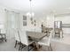 Open-concept dining area flowing into the kitchen, modern design, and natural light at 12687 Retreat Pl, Spring Hill, FL 34610