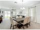 Bright dining area with modern chandelier, dining table, and sliding glass door at 12687 Retreat Pl, Spring Hill, FL 34610