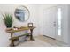 Bright foyer featuring a modern console table with a decorative mirror and a stylish rug at 12687 Retreat Pl, Spring Hill, FL 34610