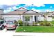 Charming single-story home featuring a well-manicured lawn and a two-car garage at 12687 Retreat Pl, Spring Hill, FL 34610